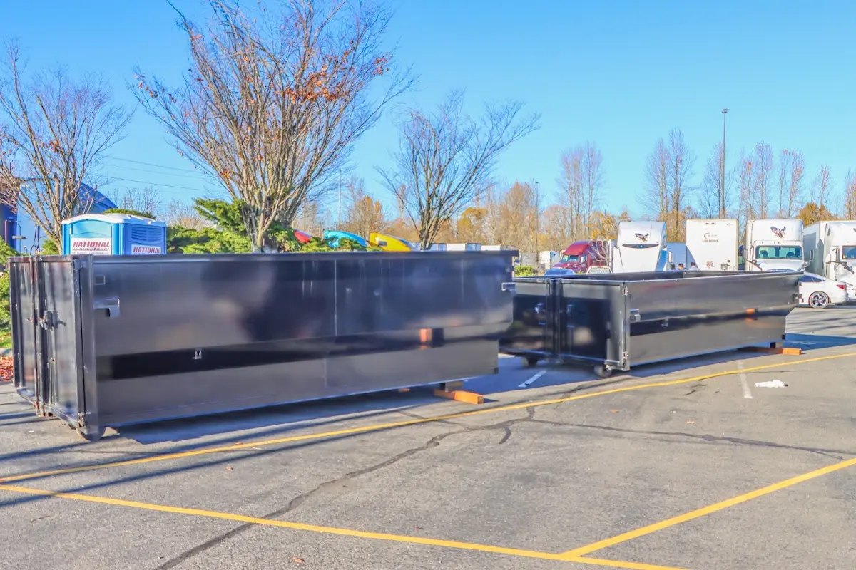 Professional dumpster rental service with roll-off container on residential driveway in Kennett